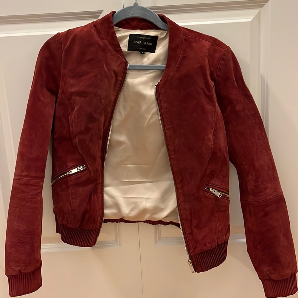 Deep red / rust suede bomber jacket. Gold zippers. Fits like an XS